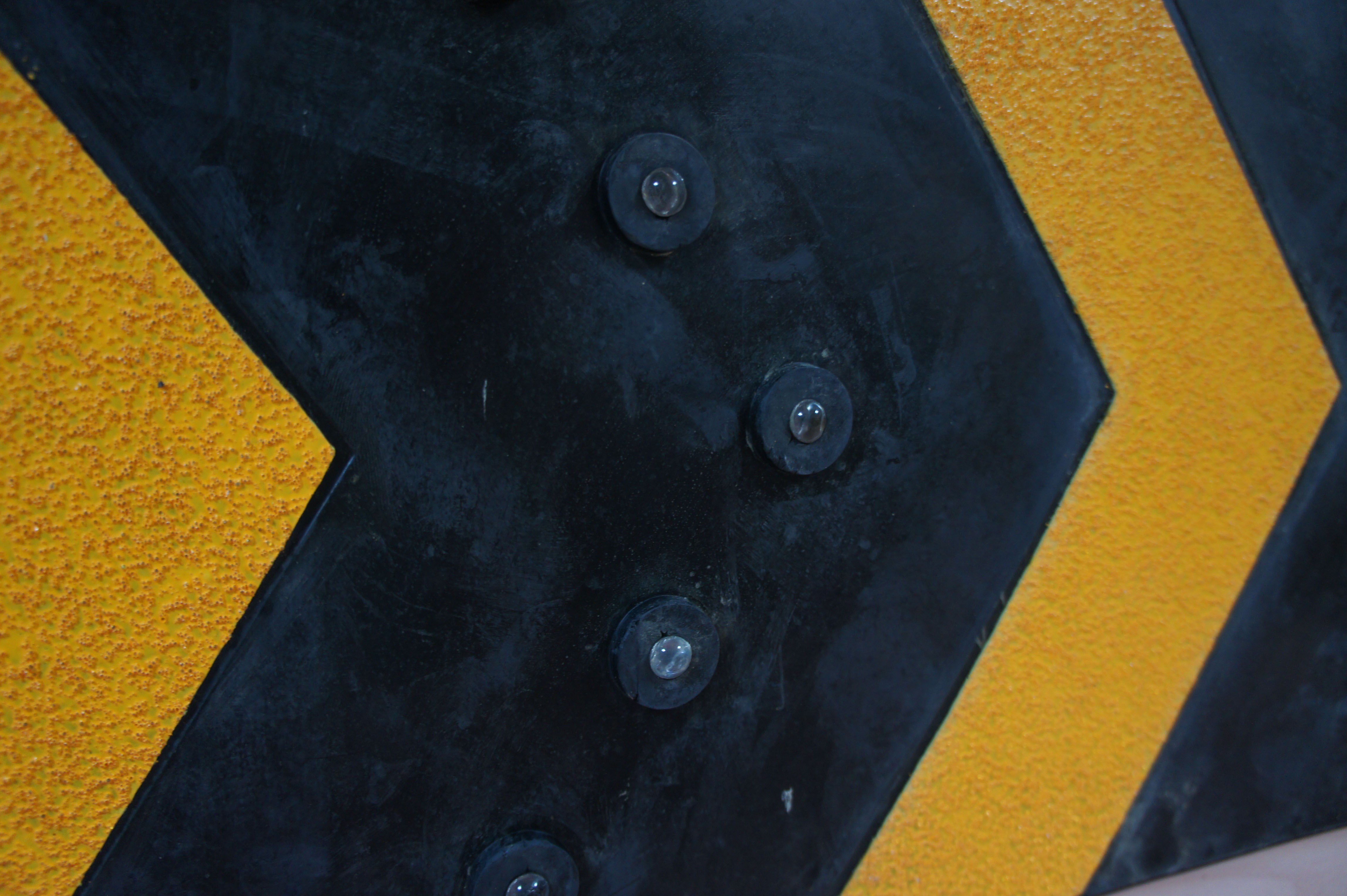 Parking signage arrow with reflectors
